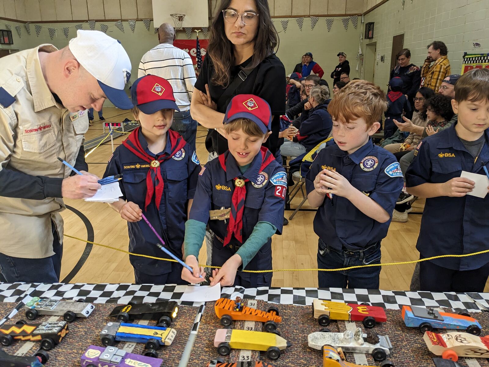Pack 209 Cub Scouts racing cars at the Pinewood Derby